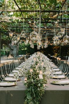 outdoor garden weddings-long table for dinner with glass lights hanging from above