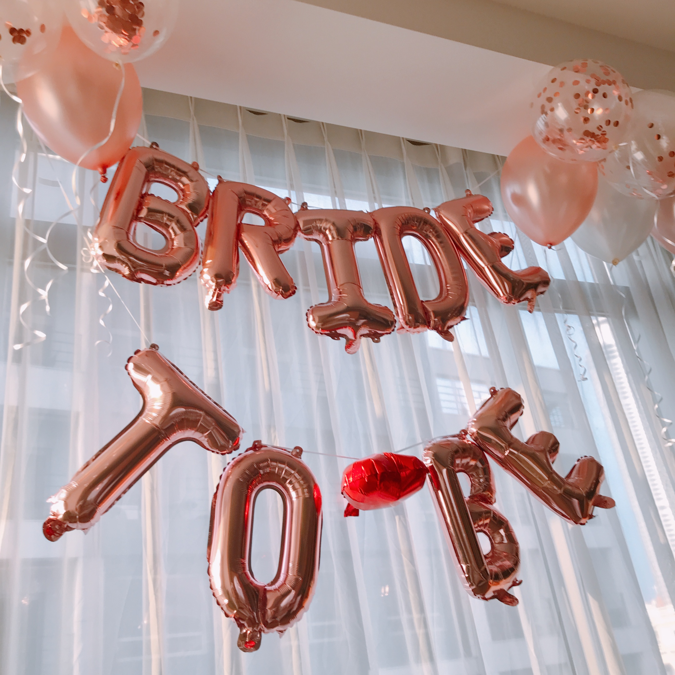 Rose colored mylar balloons that spell out bride to be. Bridal Shower Ideas-decorations.